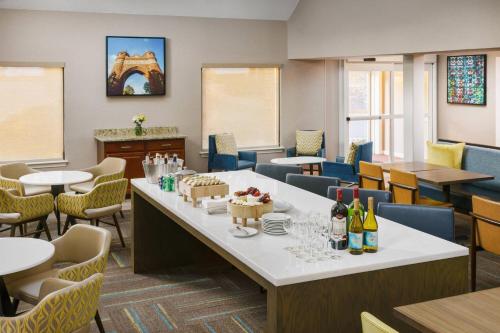 a restaurant with tables and chairs and wine bottles at Residence Inn Hartford Windsor in Windsor