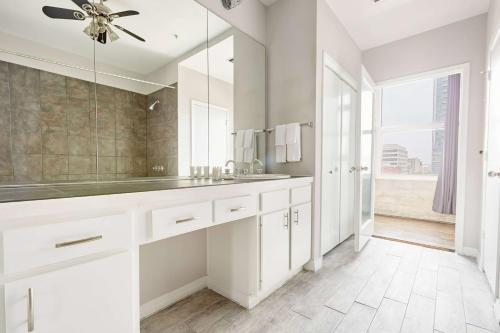 bagno bianco con lavandino e ventilatore a soffitto di Reside Houston Downtown, a Wyndham Residence a Houston