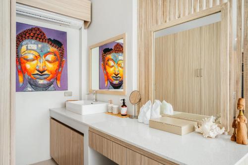 a bathroom with a sink and a mirror at Beachfront Secret Tides Villa Sol in Koh Samui 