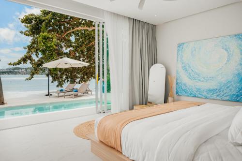 a bedroom with a bed and a view of the ocean at Beachfront Secret Tides Villa Sol in Koh Samui 