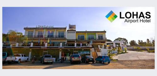 a large building with cars parked in front of it at LOHAS Airport Hotel and Restaurant in Cagayan de Oro