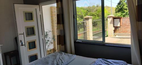 a bedroom with a bed and a window with a balcony at Casa Nathan! 2 Zimmer, Internet, Küche, Cosina, Parking, Lavanderia, Sauna! Barrio Esperanza! Central! in Hohenau