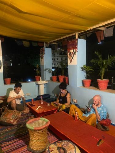 a group of people sitting at a table under a tent at Blue Eye Hostel in Jaisalmer