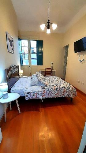 a bedroom with two beds and a television in it at CASONA SANTA MARTA in Arequipa