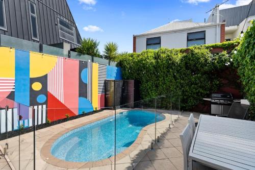 a swimming pool with a mural on the side of a building at Port Paradiso in Melbourne