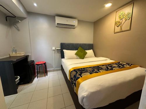 a hotel room with a bed and a desk at SS Grey House in Kuala Lumpur