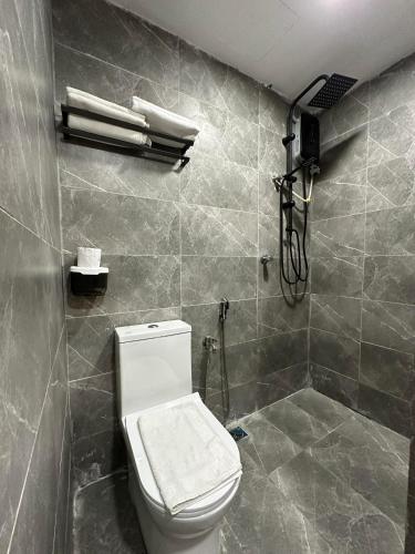 a bathroom with a toilet and a shower at SS Grey House in Kuala Lumpur