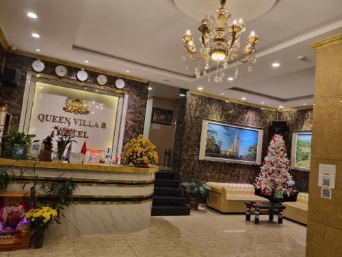 a store lobby with a christmas tree and a chandelier at Queen Villa Hotel 2 DL - by BAY LUXURY in Da Thien