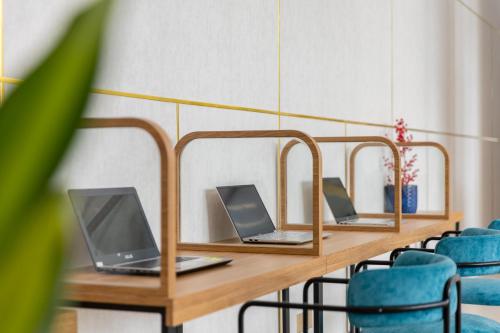 a row of desks with laptops on them at Petro House Vung Tau - Block A in Vung Tau