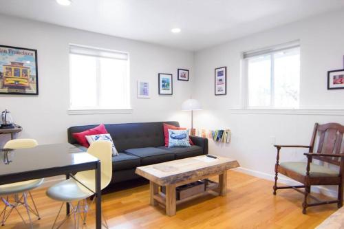 a living room with a couch and a table at 1br in quaint area, subway 12 mins to downtown, free EVcharge in San Francisco