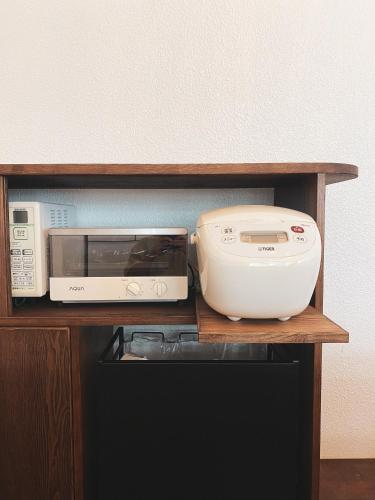 a shelf with a toaster oven and a printer on it at ASAHi in Ikei
