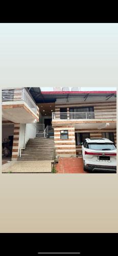 a car parked in a parking lot in front of a building at The Ivyview Villa Kumarhatti Barog Near Kasauli in Barog