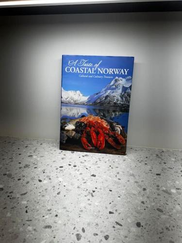 a book on coastal norway sitting on a wall at Gammelgårdvegen 31 in Tromsø