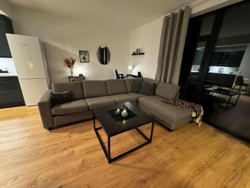 a living room with a couch and a table at Gammelgårdvegen 31 in Tromsø