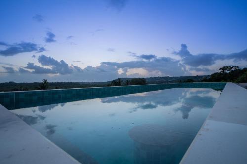 a swimming pool with a view of the sky at ELIVAAS 1 BHK with Rooftop Pool - Kamerios Verano in Goa