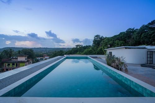 a swimming pool on the roof of a house at ELIVAAS 1 BHK with Rooftop Pool - Kamerios Verano in Goa