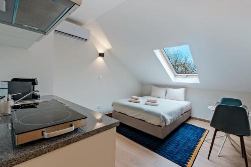 a small room with a bed and a sink at Lovely studio fully equipped near subway N11 - Shared bathroom with another Studio in Lisbon