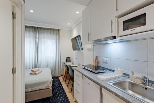a kitchen with a sink and a counter top at Lovely studio fully equipped near subway N5 in Lisbon