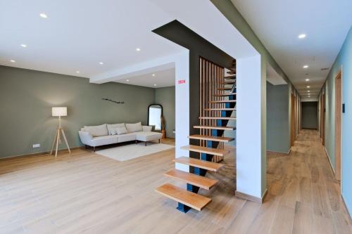 a staircase in a living room with a couch at Lovely studio fully equipped near subway N8 in Lisbon