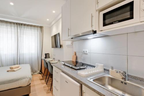 a kitchen with a sink and a counter top at Lovely studio fully equipped near subway N13 in Lisbon