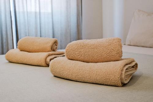 two stacks of towels sitting on a floor at Lovely studio fully equipped near subway N3 in Lisbon