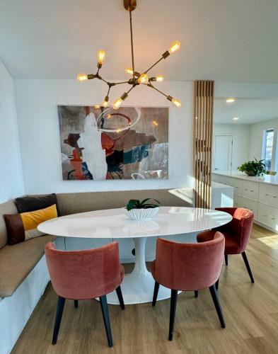 a living room with a white table and chairs at Modern Home with private beach on St. Croix River in Lakeland