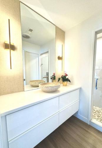 a bathroom with a sink and a mirror at Modern Home with private beach on St. Croix River in Lakeland