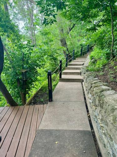 a path in a park with a wooden fence at Modern Home with private beach on St. Croix River in Lakeland
