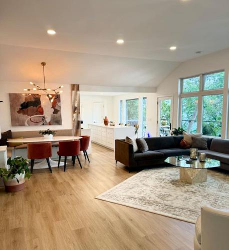 a living room with a couch and a table at Modern Home with private beach on St. Croix River in Lakeland