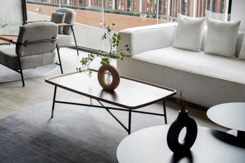 a living room with a couch and a table at Arden Hotel and Residence by At Mind in Pattaya Central