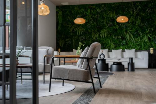 a dining room with a table and a chair at Arden Hotel and Residence by At Mind in Pattaya Central