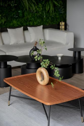 a coffee table with a plant on top of it at Arden Hotel and Residence by At Mind in Pattaya Central