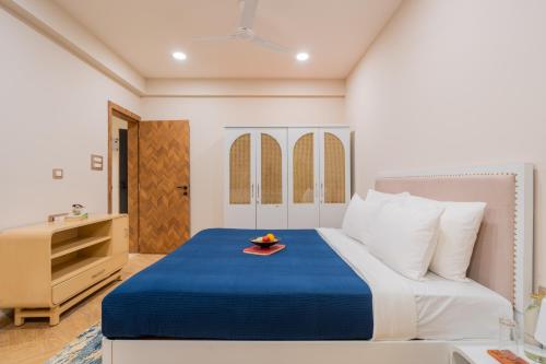 a bedroom with a bed with a plate of fruit on it at ELIVAAS 1 BHK with Jacuzzi & Lift - Kamerios Brisa in Goa
