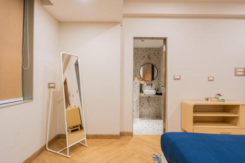 a bedroom with a blue bed and a mirror at ELIVAAS 1 BHK with Jacuzzi & Lift - Kamerios Brisa in Goa