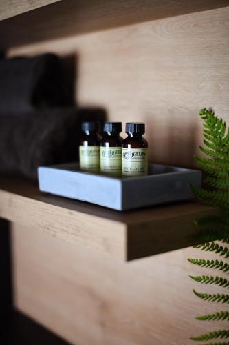 three bottles of essential oils sitting on a shelf at Hotel Nice in Laupheim