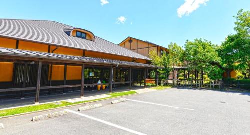 a parking lot in front of a building at 池の山荘 in Yame