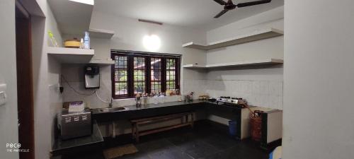 a kitchen with a large sink and a window at the motville in Pulpally