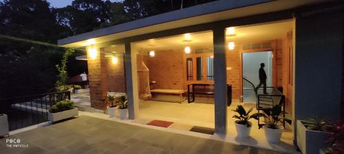 a screened in porch of a house with lights at the motville in Pulpally