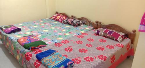 a bedroom with a bed with a comforter on it at Two BHK Fully Furnished Flat - Near Charminar and Salar Jung Museum in Hyderabad