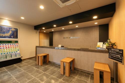 a fast food restaurant with a counter and benches at Hotel Route-Inn Toyohashi Ekimae in Toyohashi