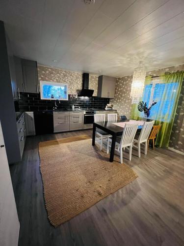a kitchen with a table and chairs and a television at Villa i Kiruna in Kiruna