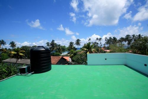 a view from the roof of a house with a green roof at Villa Mathe in Dickwella