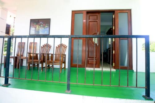 a balcony with chairs and a table on it at Villa Mathe in Dickwella