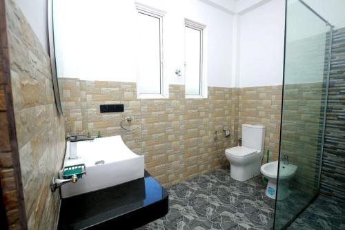 a bathroom with a sink and a toilet at Villa Mathe in Dickwella