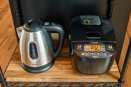 a coffee maker and a toaster sitting on a shelf at VILLA Naebo Sapporo Beer Park Hocance in Sapporo