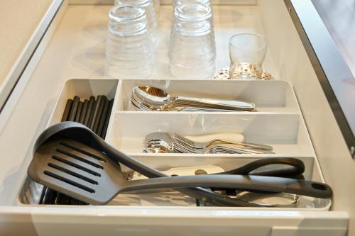 a drawer filled with utensils and a spatula at VILLA Naebo Sapporo Beer Park Hocance in Sapporo