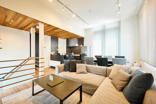 a living room with a couch and a table at VILLA Naebo Sapporo Beer Park Hocance in Sapporo