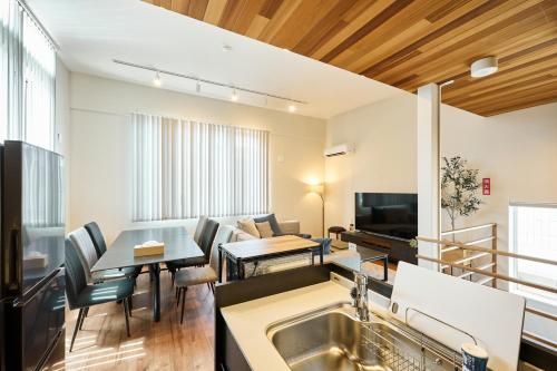 a kitchen and living room with a sink and a table at VILLA Naebo Sapporo Beer Park Hocance in Sapporo