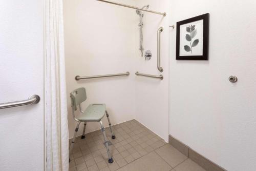 a small bathroom with a chair in a room at Country Inn & Suites by Radisson, Fargo, ND in Fargo