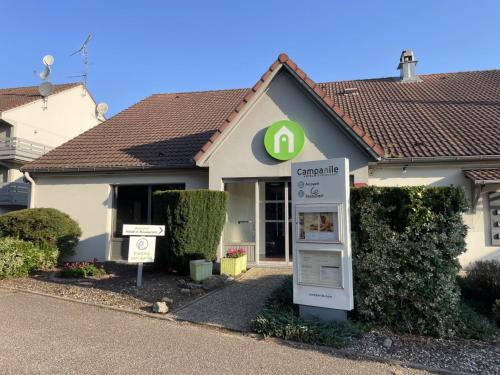 a house with a sign in front of it at Campanile Saint-Avold in Saint-Avold